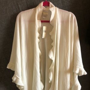 Cream colored cape with ruffle detail